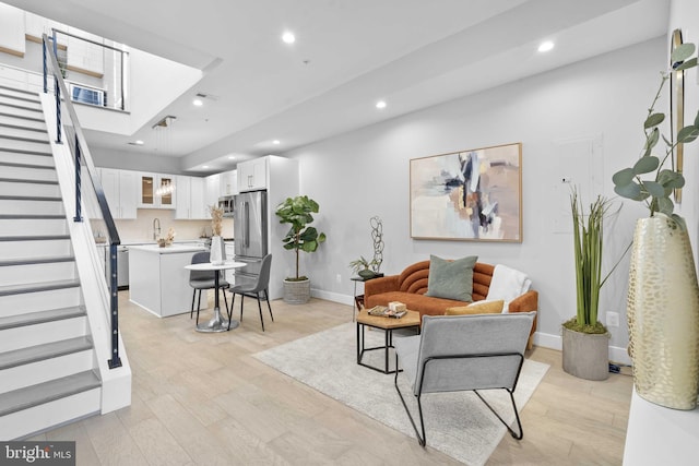 living room featuring sink and light wood-type flooring