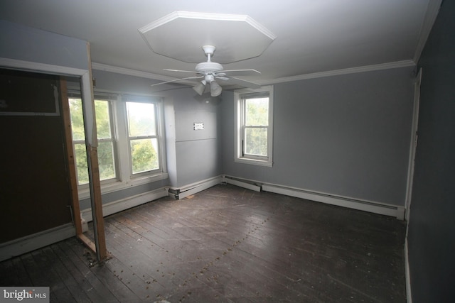 empty room featuring ceiling fan, dark hardwood / wood-style flooring, crown molding, and a baseboard heating unit