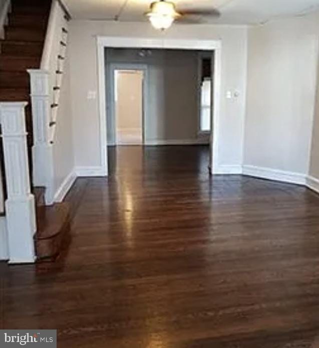 unfurnished dining area with dark wood-type flooring