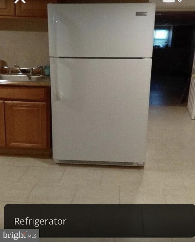 kitchen with white fridge and sink