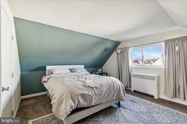 carpeted bedroom featuring radiator and lofted ceiling