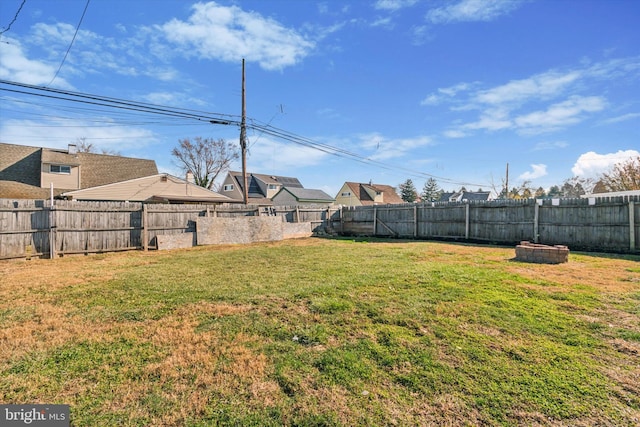 view of yard with a fire pit