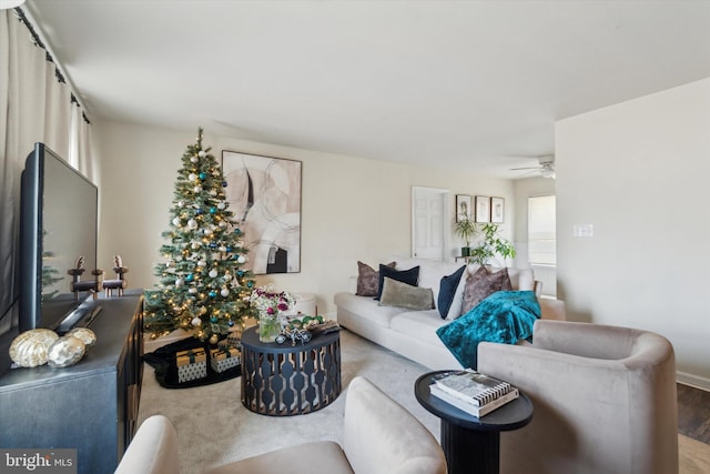 living room featuring hardwood / wood-style floors and ceiling fan