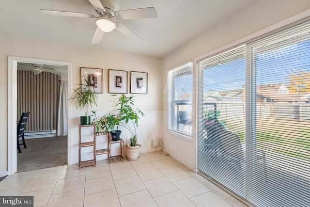 doorway with ceiling fan and light tile patterned flooring