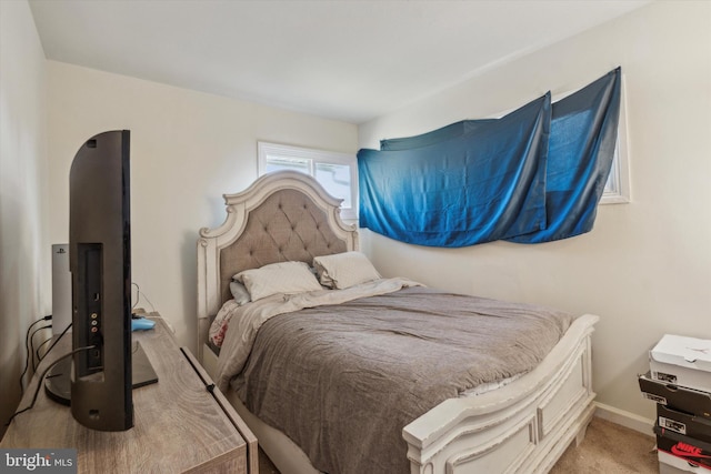 bedroom featuring light colored carpet