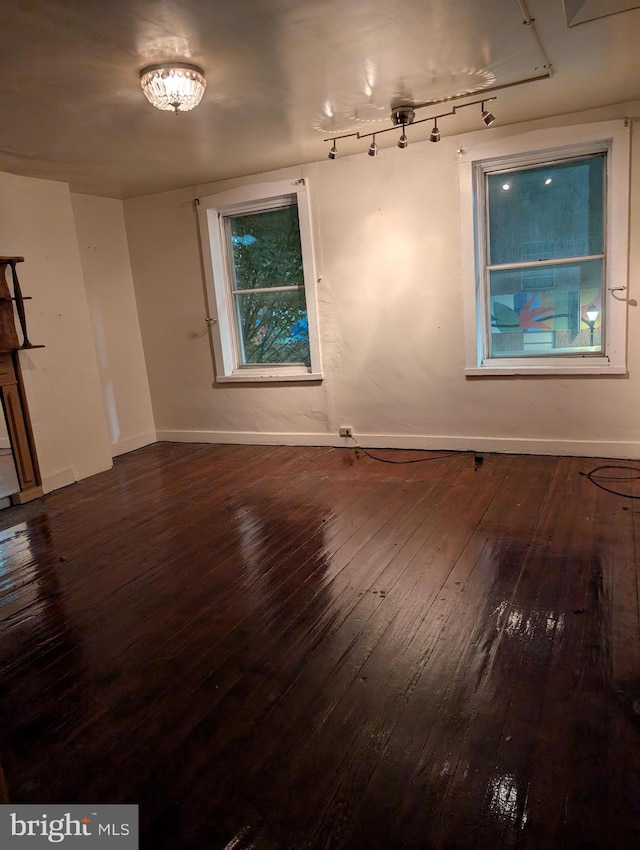 unfurnished room featuring dark hardwood / wood-style floors