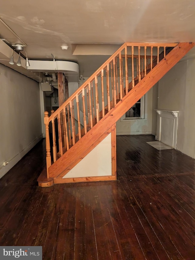 staircase with hardwood / wood-style flooring