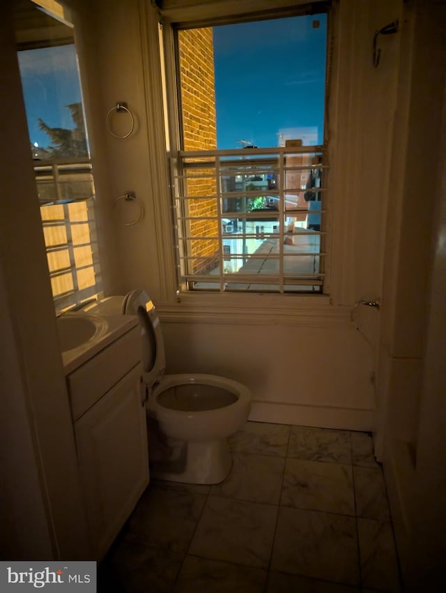 bathroom featuring tile patterned floors, vanity, and toilet