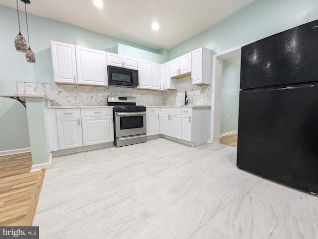 kitchen with decorative backsplash, hanging light fixtures, white cabinets, and black appliances