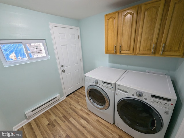 laundry area featuring independent washer and dryer, light hardwood / wood-style flooring, cabinets, and a baseboard heating unit