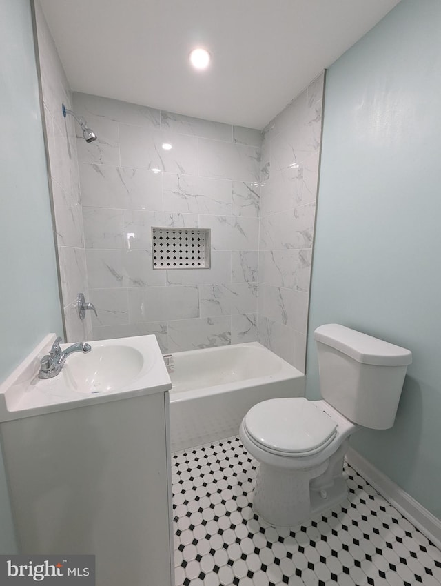 full bathroom featuring tiled shower / bath, tile patterned floors, vanity, and toilet