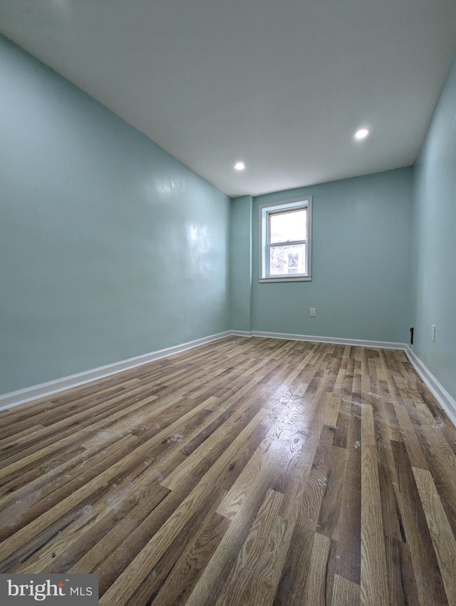 empty room with dark wood-type flooring