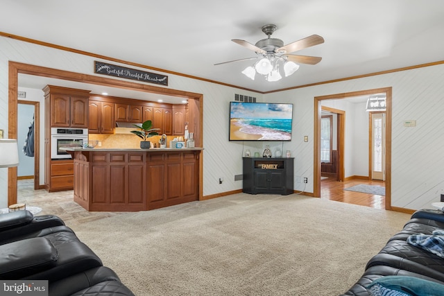 living room with light carpet, ceiling fan, and ornamental molding