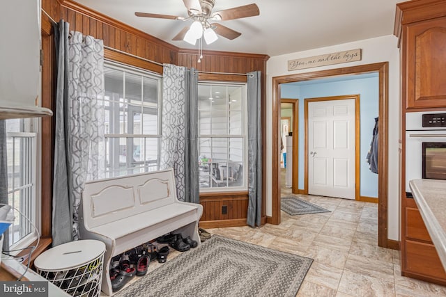 sitting room with plenty of natural light and ceiling fan