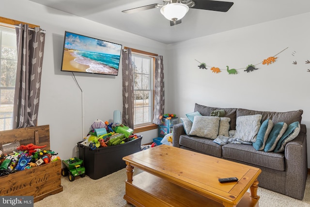 living room with light carpet and ceiling fan