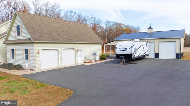 1060 Edwardsville Rd, Felton, DE 19943 - view of property exterior with a detached garage and a shingled roof