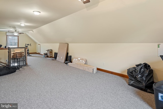 additional living space with carpet flooring, ceiling fan, and vaulted ceiling