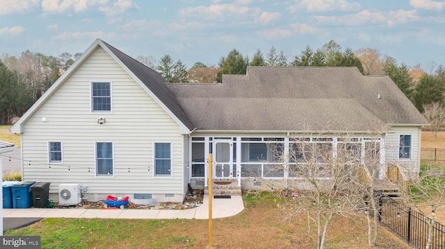 rear view of house with ac unit and a sunroom