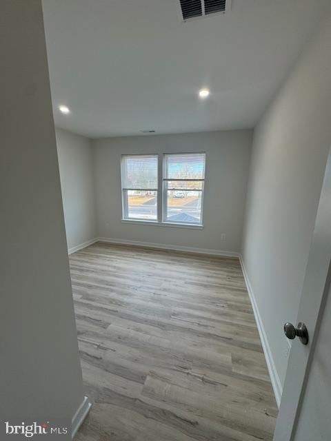 empty room with light hardwood / wood-style flooring