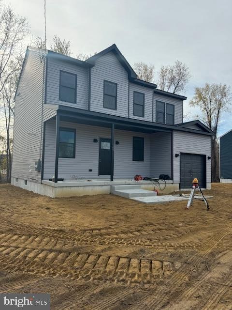 view of front property featuring a garage and covered porch