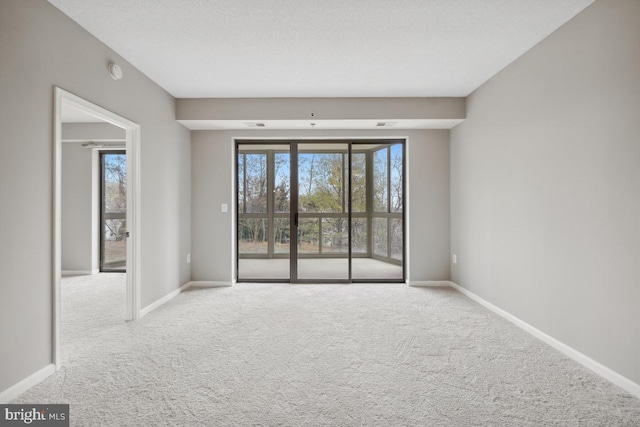 unfurnished room with a wealth of natural light and light colored carpet