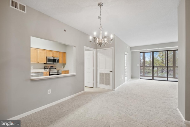 interior space featuring a chandelier, a textured ceiling, and light colored carpet