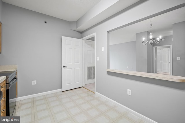 unfurnished dining area with a chandelier