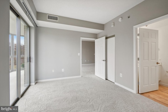 unfurnished bedroom with access to outside and light colored carpet