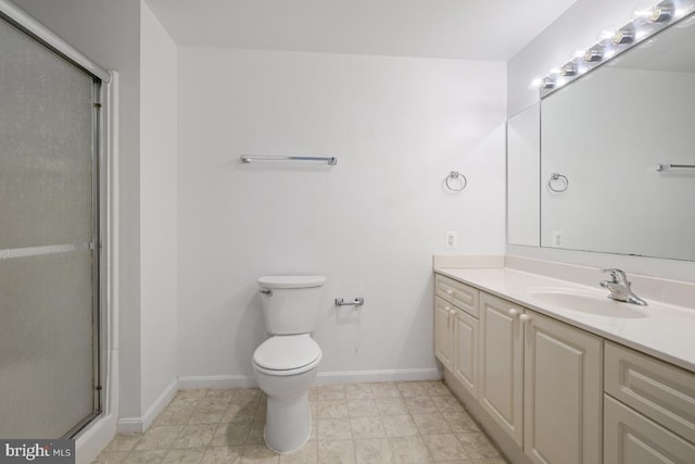 bathroom with vanity, toilet, and walk in shower