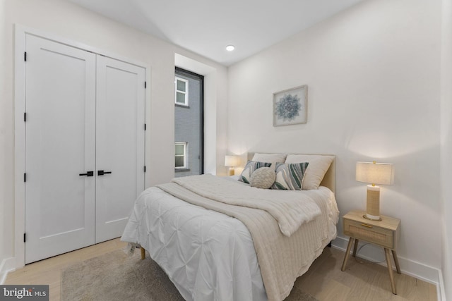 bedroom featuring light hardwood / wood-style floors and a closet