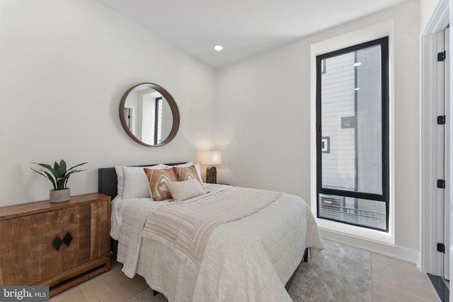 bedroom featuring light hardwood / wood-style floors and multiple windows