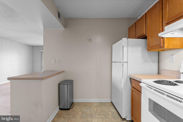 kitchen featuring white electric range oven and a textured ceiling