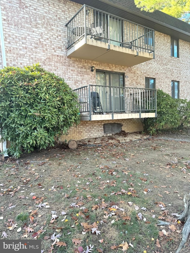 back of property with a balcony