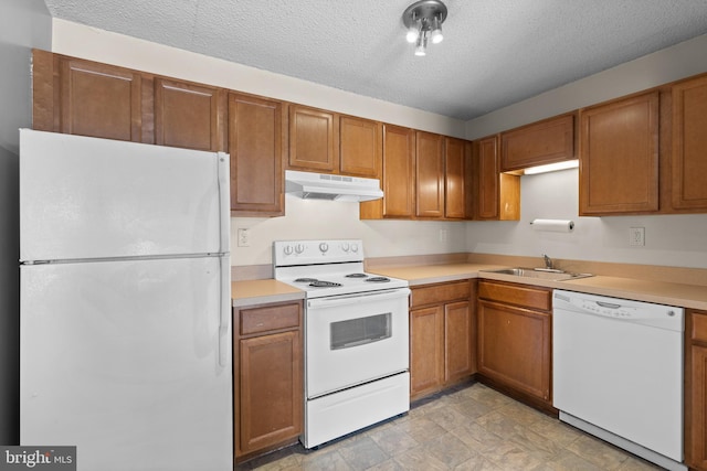 kitchen featuring sink, a textured ceiling, and white appliances