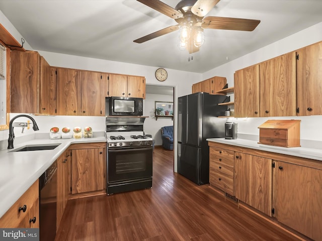 kitchen featuring sink, dark hardwood / wood-style floors, ceiling fan, and black appliances