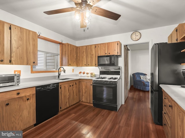 kitchen featuring sink, dark hardwood / wood-style floors, ceiling fan, and black appliances