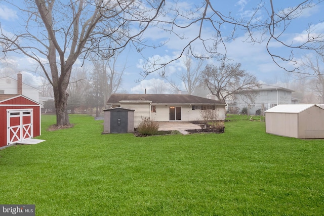 back of house with a yard, a shed, and a patio area