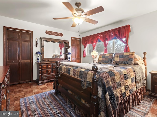 bedroom with ceiling fan and parquet flooring