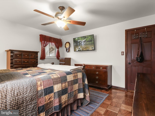 bedroom featuring dark parquet flooring and ceiling fan