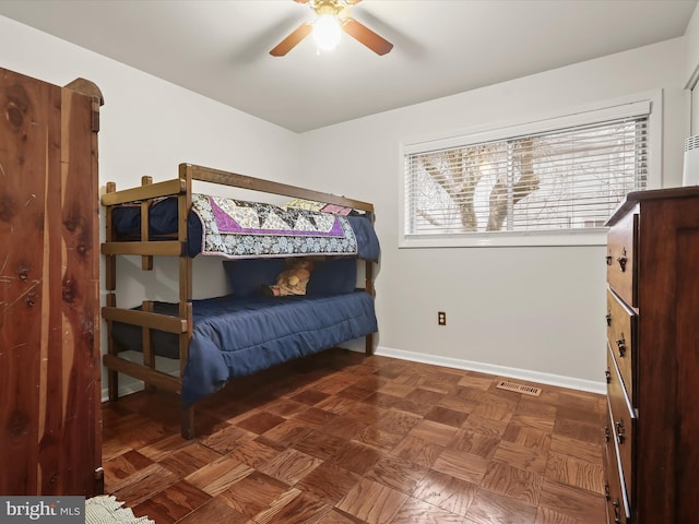 bedroom featuring ceiling fan and dark parquet floors