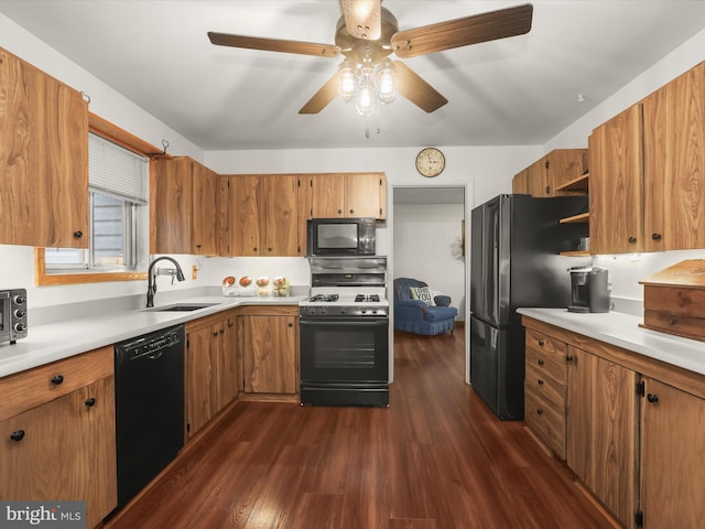 kitchen with black appliances, dark hardwood / wood-style floors, ceiling fan, and sink