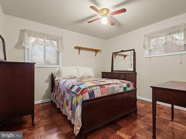 bedroom with dark parquet flooring and ceiling fan