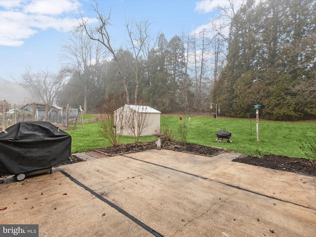 view of patio featuring area for grilling and a storage shed