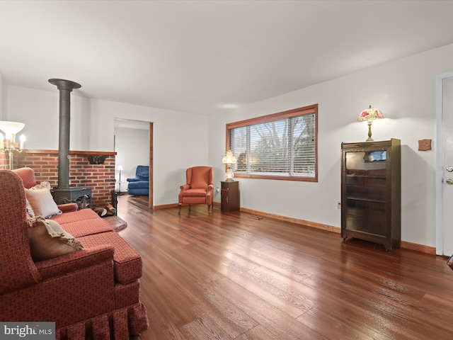 living room with dark hardwood / wood-style flooring and a wood stove