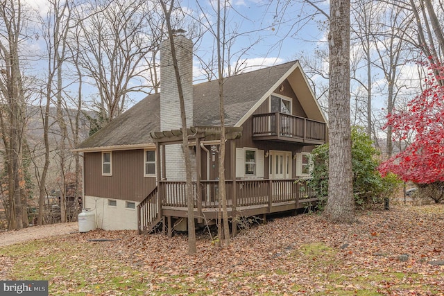 back of house featuring a balcony