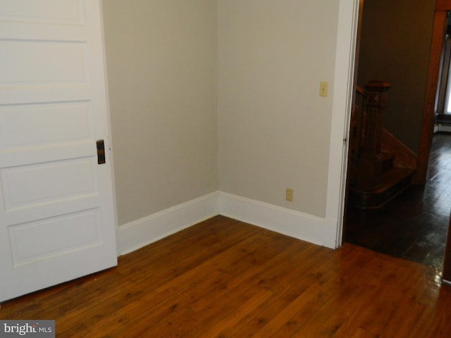 empty room with dark hardwood / wood-style floors