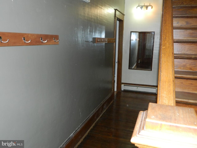 hallway with baseboard heating and dark wood-type flooring