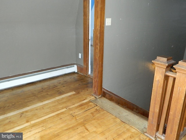 interior details with wood-type flooring and baseboard heating