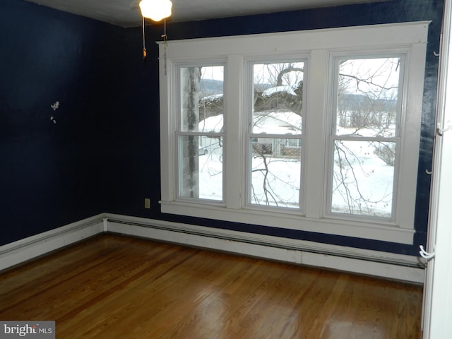 interior space with baseboard heating and hardwood / wood-style floors