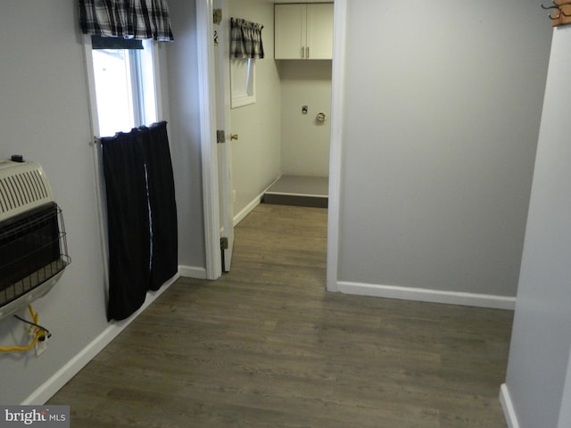 hall featuring heating unit and dark wood-type flooring